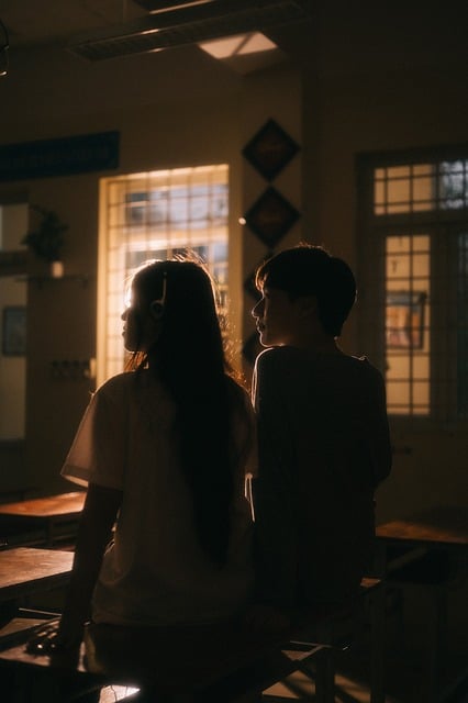 girl, portrait, school, student, headphones, lighting, shadows, silhouette, window, interior, vietnam, couple, classmates, low lighting, casual, youth, asian, sitting, back to camera, angle