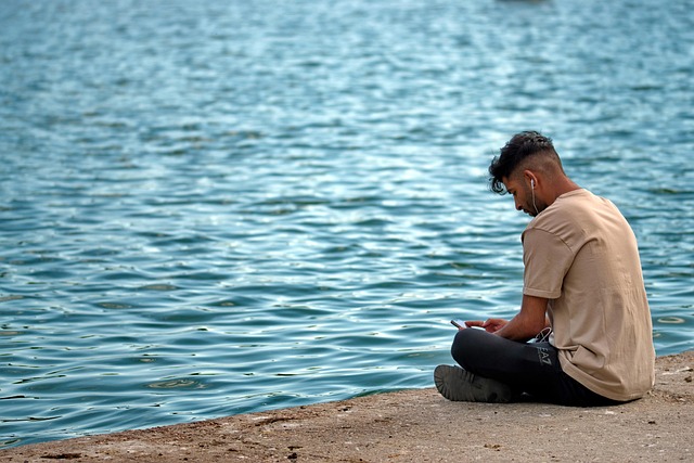 boy, young, phone, relaxation, spring, park, lakeshore, recreation, person, listening, music, headphones, smartphone, ears, nature, water, snapshot, free time